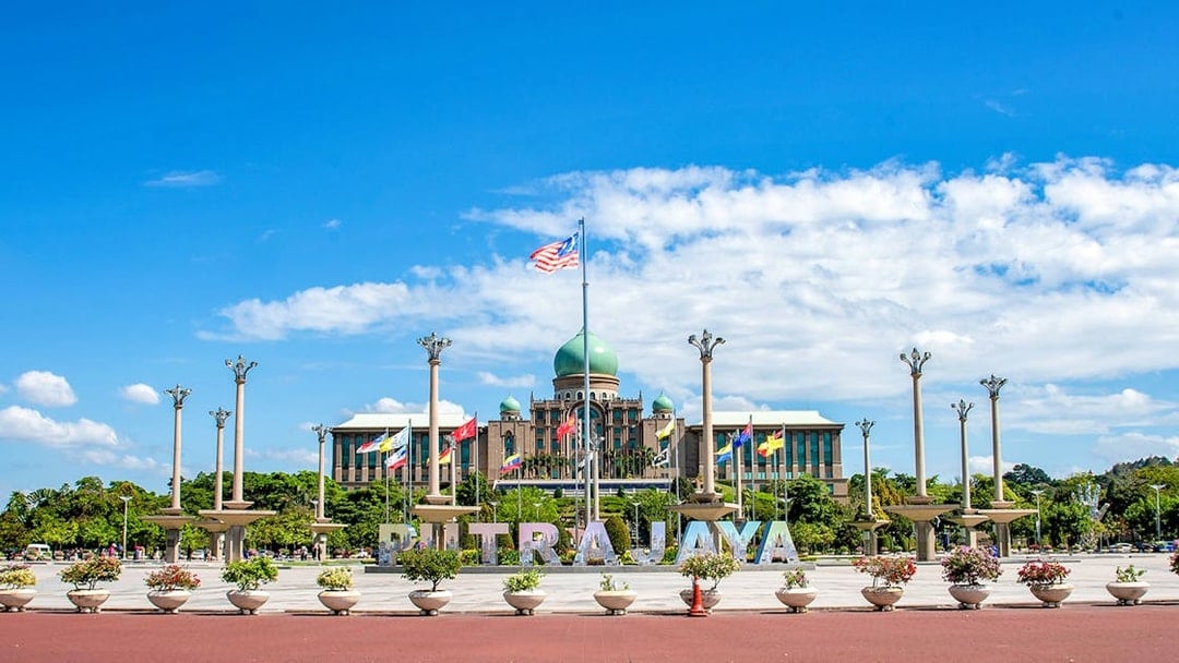 Putrajaya government complex with flags and domed building, Malaysia.