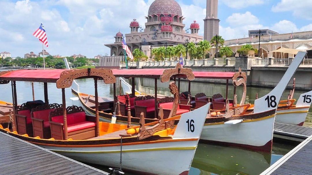 Boats docked at Tasik Putrajaya with Putra Mosque in the background.
