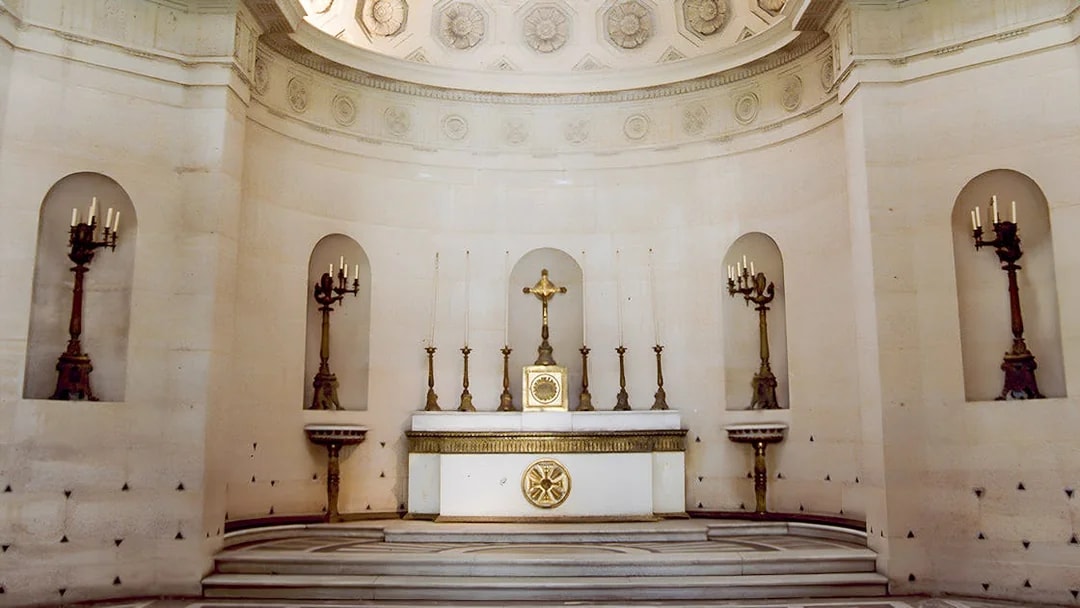 Expiatory Chapel altar with ornate candlesticks and crucifix in Paris, France.