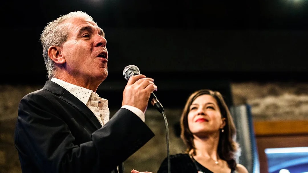 Fado singers performing in a Port wine cellar concert.