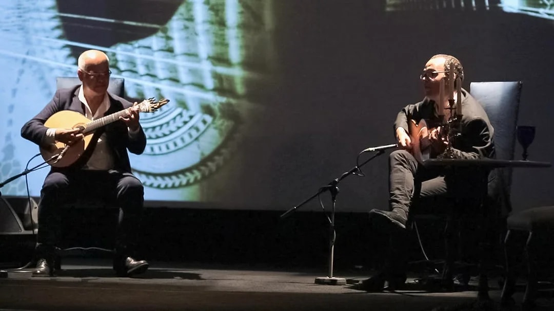 Musicians performing Fado in Chiado, Lisbon, with guitars on stage.