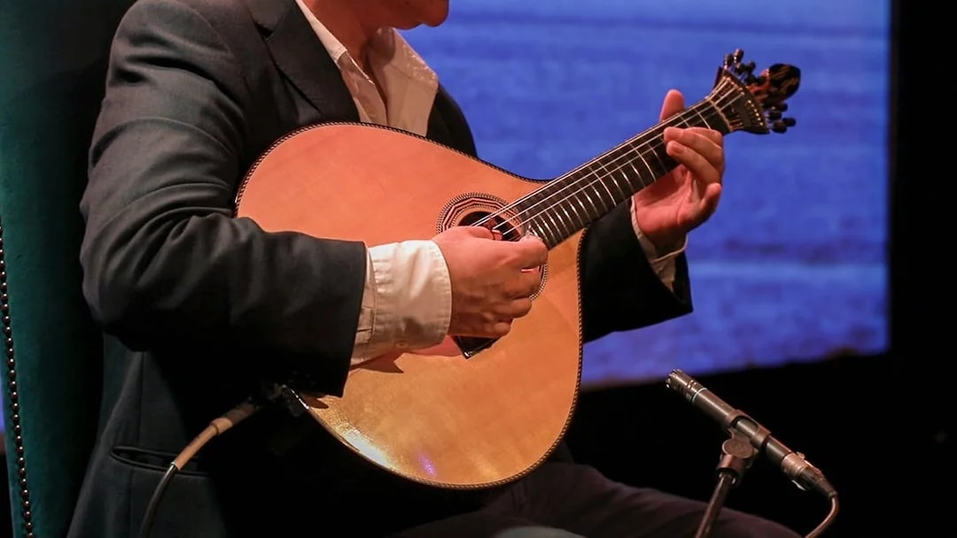 Musician playing Portuguese guitar at Fado in Chiado, Lisbon.