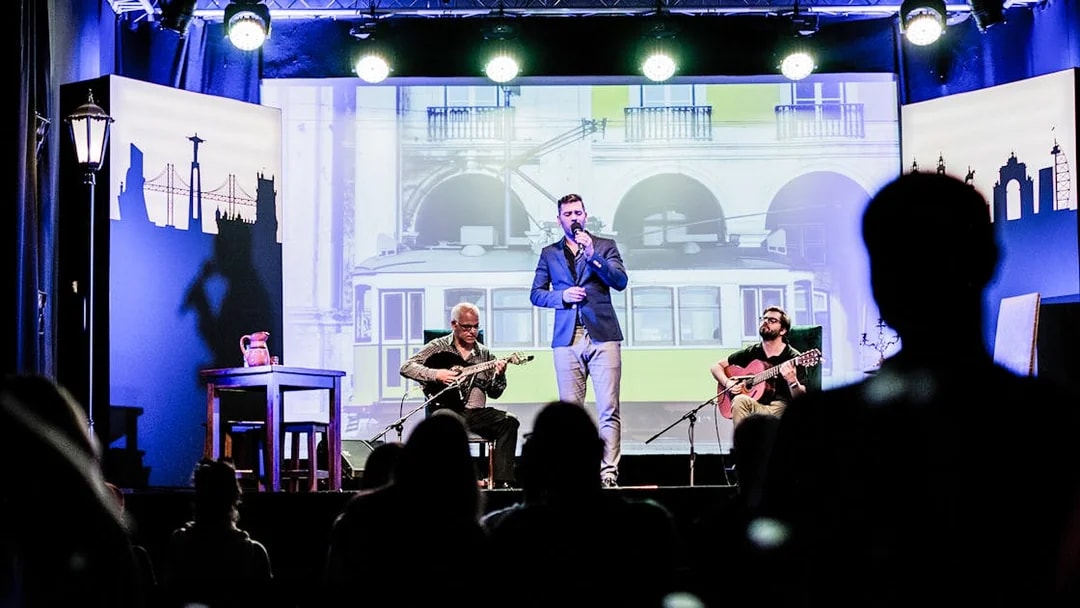 Fado performance in Chiado with musicians and singer on stage, Lisbon backdrop.