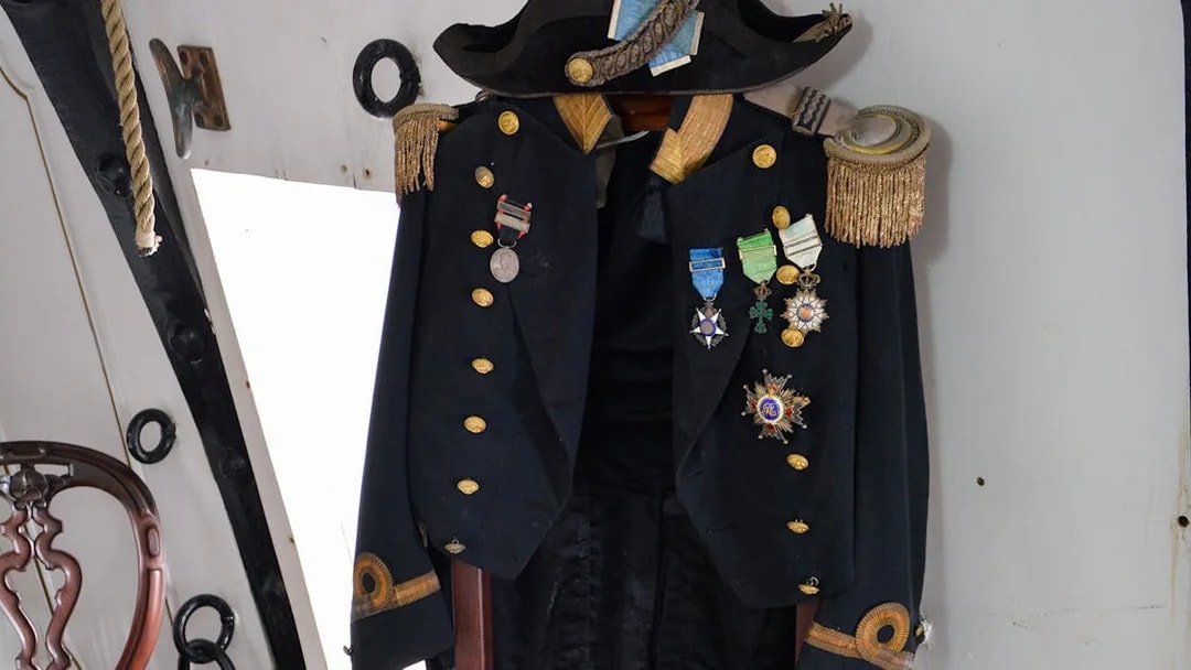 Navy officer's uniform with medals on display aboard Frigate D. Fernando II e Glória.