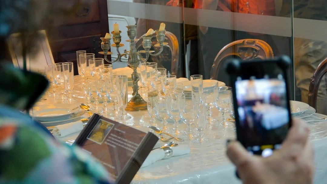 Dining table setup with glassware and candelabra on Frigate D. Fernando II e Glória.