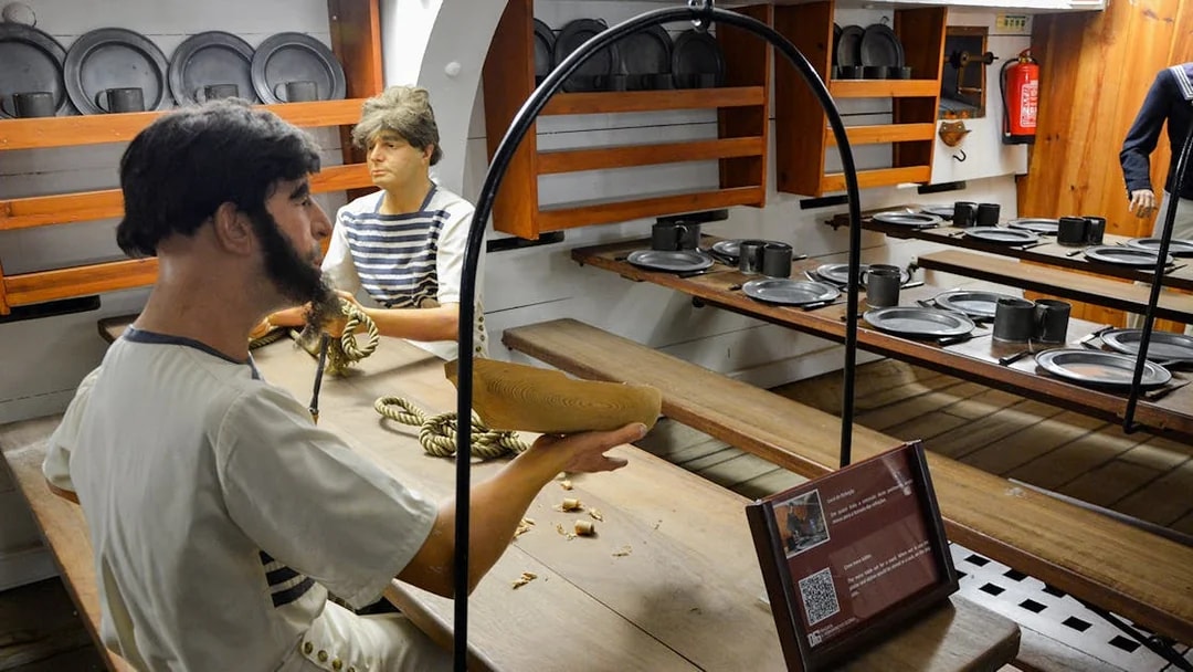 Crew members crafting ropes in the dining area of Frigate D. Fernando II e Glória.