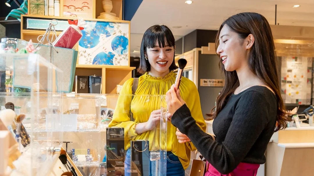 Visitors exploring gift shop at Hiroshima Orizuru Tower.