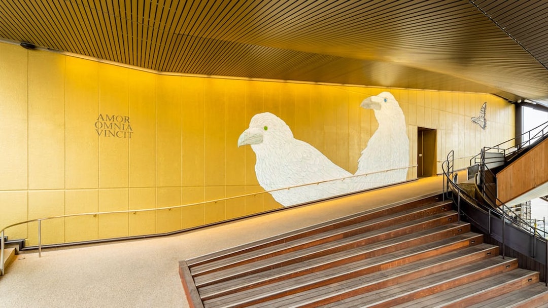 Hiroshima Orizuru Tower interior with bird mural and staircase.