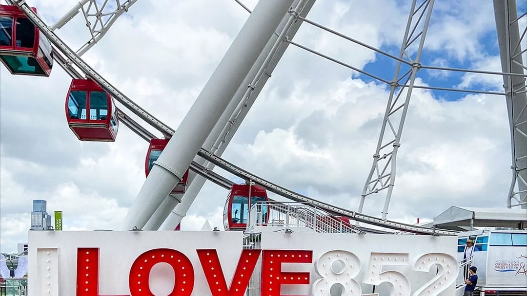 Hong Kong Observation Wheel with "LOVE 852" sign in foreground.