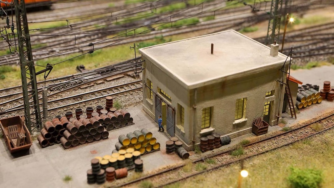 Miniature railway scene with building and barrels at Hzero Miniature Railway Museum.