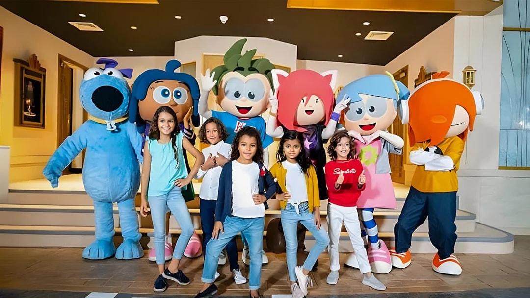 Kids posing with mascots at KidZania, Abu Dhabi.
