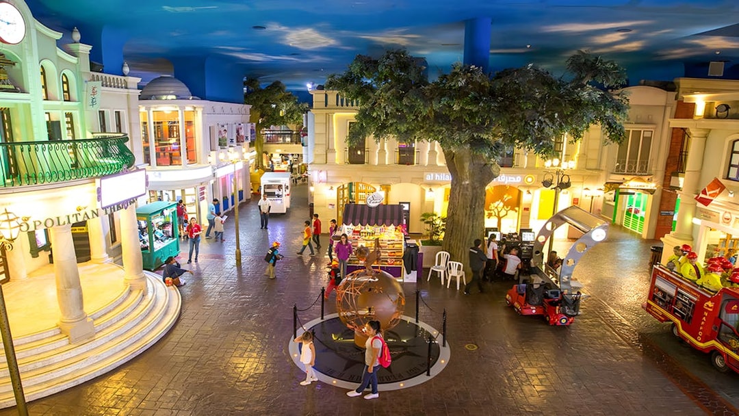 KidZania Abu Dhabi streets with children exploring interactive shops and activities.