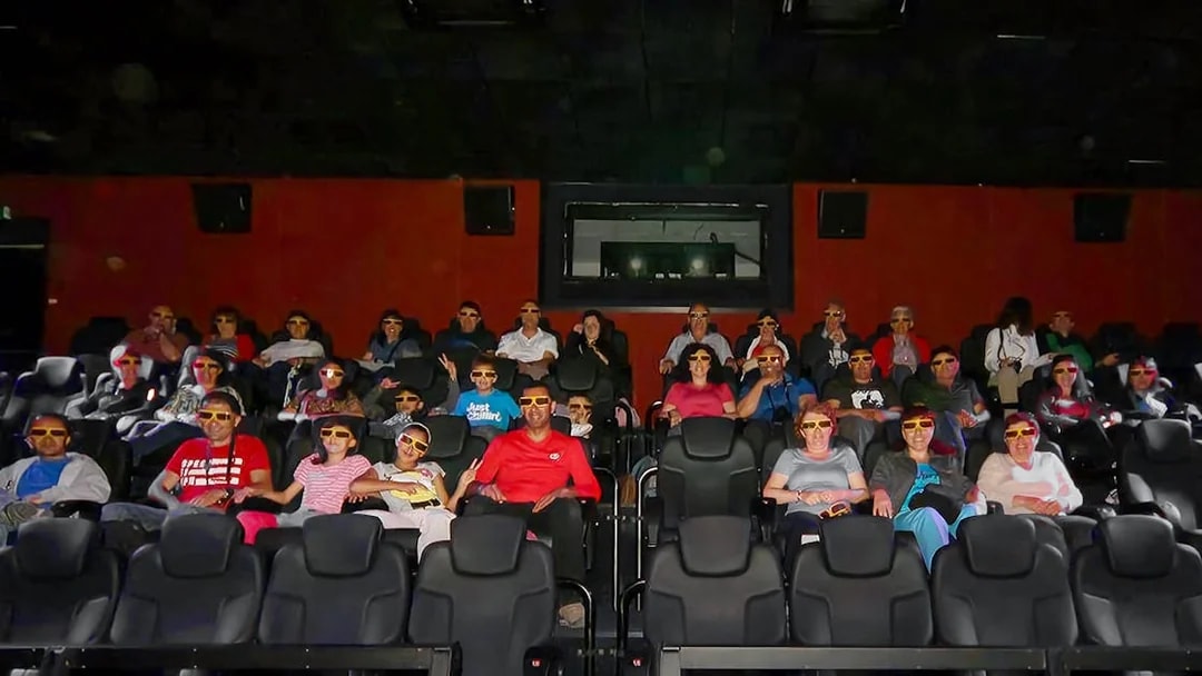 Visitors wearing 3D glasses seated in the viewing hall at Malta 5D Audio-Visual Show.