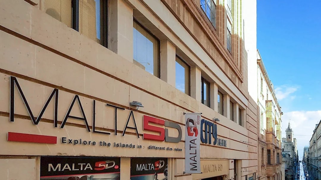 Malta 5D Show entrance on a city street with historic architecture.