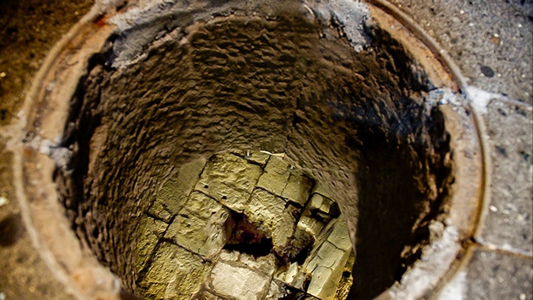 Mamertine Prison ancient stone well entrance in Rome.