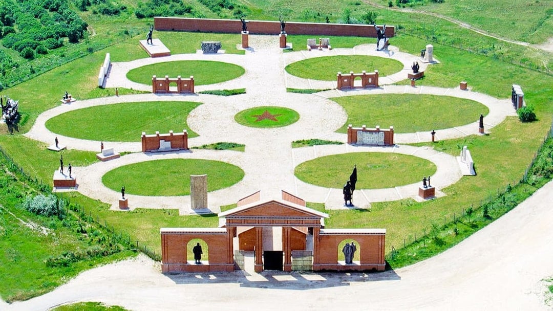 Aerial view of Memento Park in Budapest featuring statues and circular pathways.