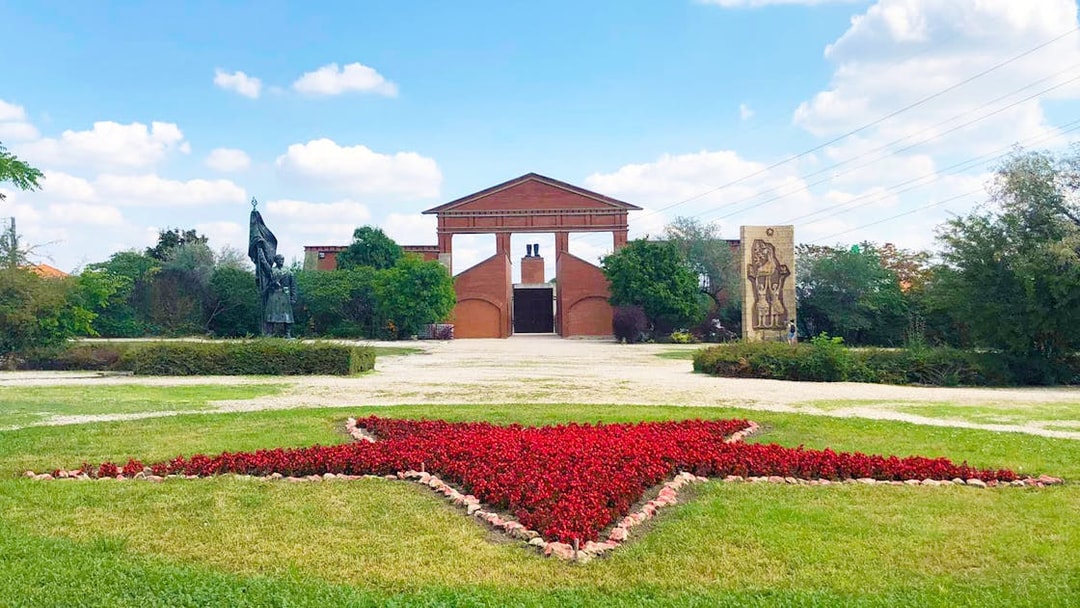 Entrance of Memento Park with red star flowerbed, Budapest.