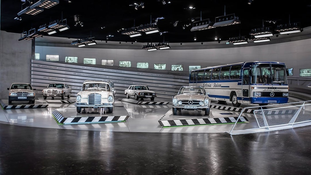 Classic Mercedes-Benz vehicles displayed inside Mercedes-Benz Museum.