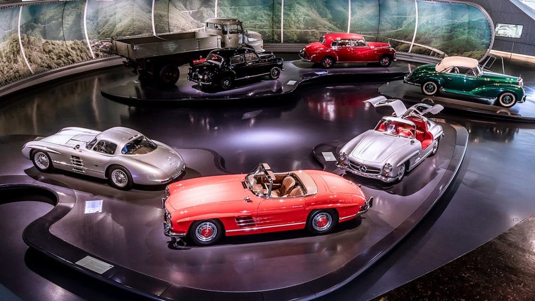 Mercedes-Benz sedans and convertibles displayed in a museum exhibit.