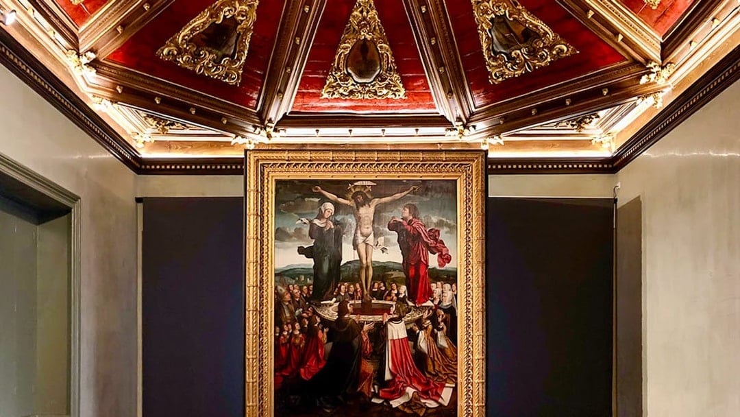 Crucifixion painting in Misericórdia Museum, Porto, with ornate ceiling detail.