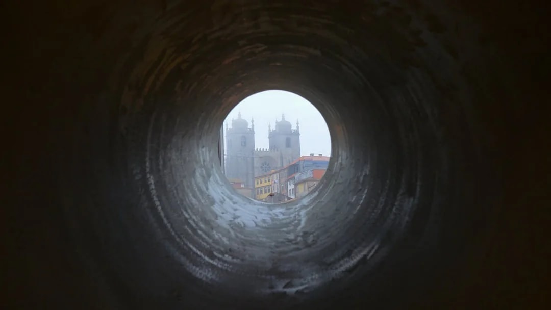 View of Porto Cathedral through a circular tunnel, Porto, Portugal.