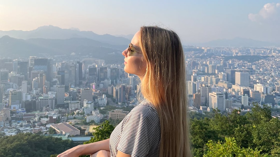 Person enjoying Seoul cityscape view from N Seoul Tower.