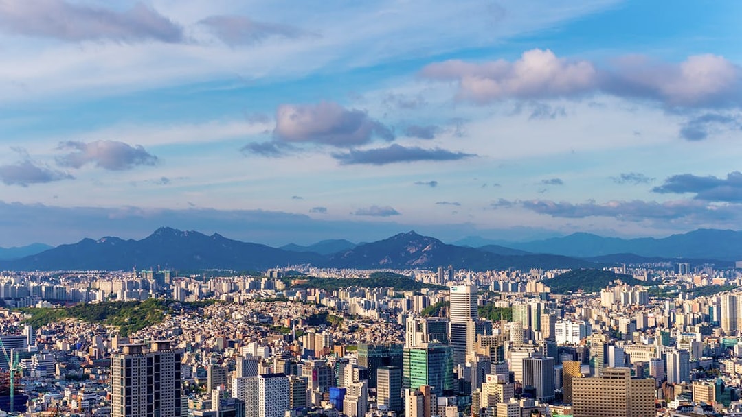 Aerial view of Seoul skyline with mountains in the background from N Tower.