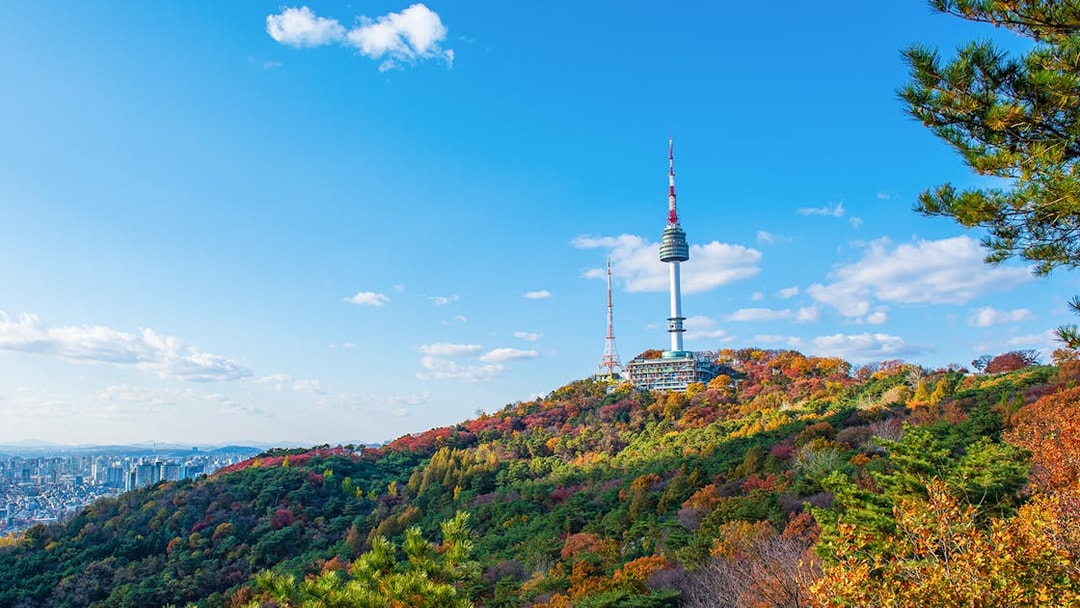 N Seoul Tower on Namsan Mountain with autumn foliage in Seoul, South Korea.