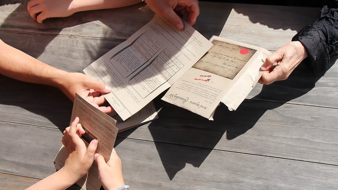 Participants examining mystery documents during Nyhavn adventure in Copenhagen.