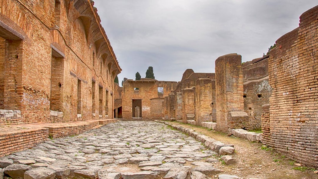 Ancient Roman ruins with stone pathway at Ostia Archaeological Park, Italy.