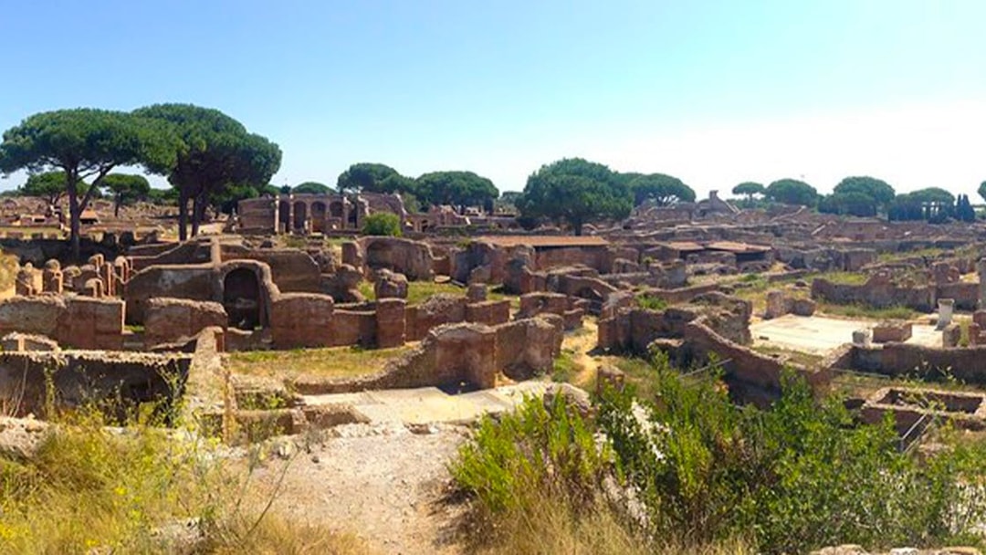 Ancient ruins and trees at Ostia Archaeological Park, Italy.