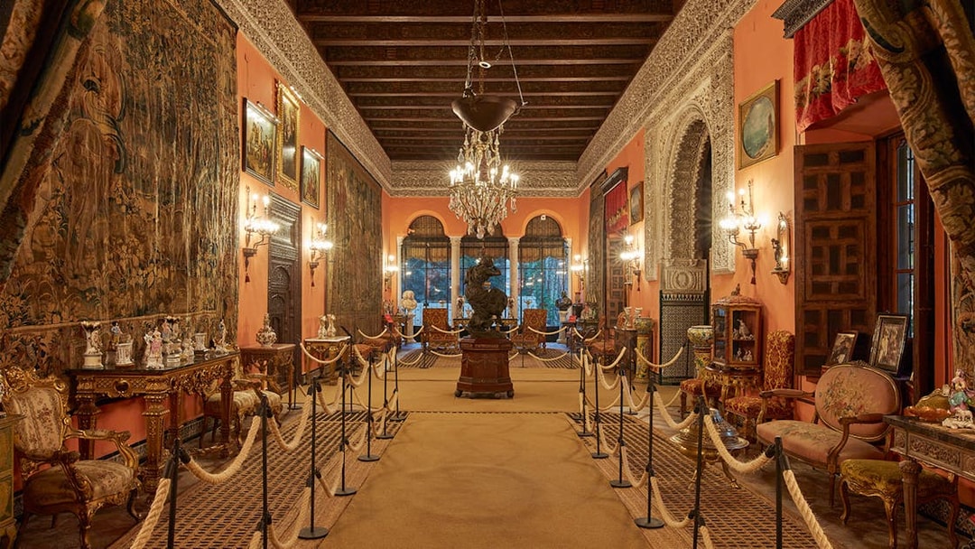 Palacio de las Dueñas interior with ornate decor and chandeliers, Seville.