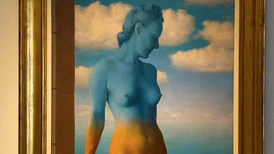 Surreal painting of a blue and orange figure against a cloudy sky at Peggy Guggenheim Collection.