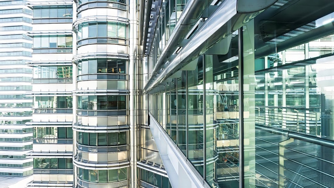Skybridge exterior of Petronas Twin Towers, Kuala Lumpur, with glass and steel architecture.