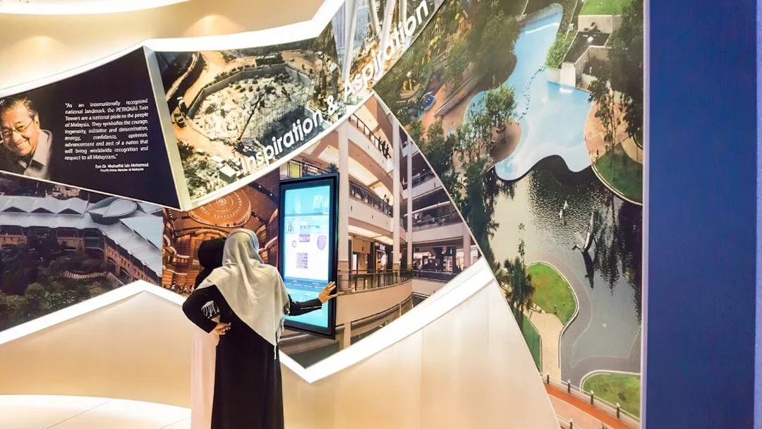 Visitors exploring Petronas Twin Towers exhibit in Kuala Lumpur.