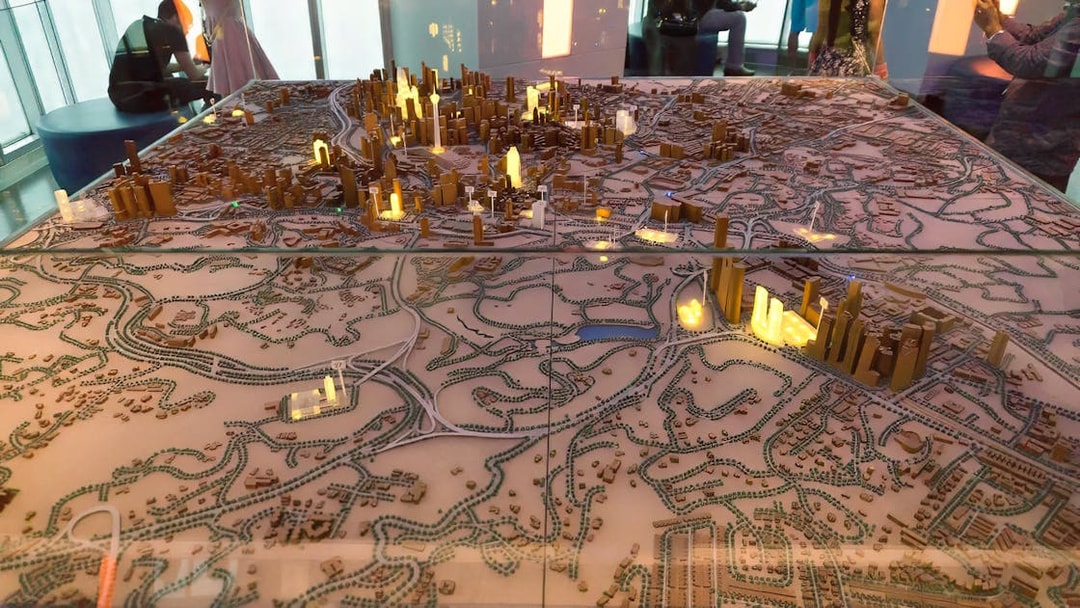 Model of Kuala Lumpur cityscape with illuminated Petronas Twin Towers.