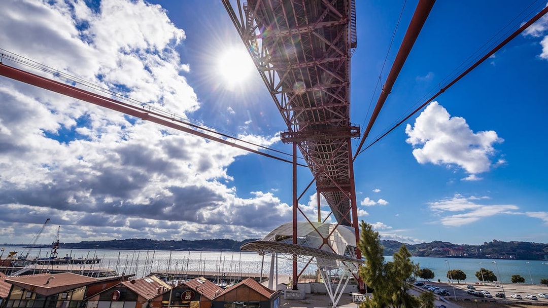 Pilar 7 Bridge Experience view from below with river and marina in Lisbon.