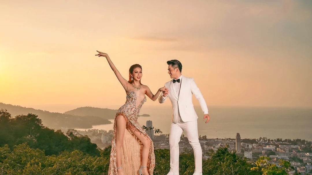 Performers at Simon Cabaret Show with Phuket cityscape in the background.
