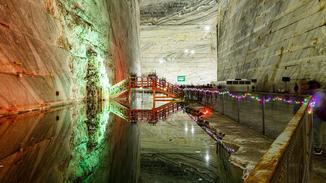 Slanic Prahova Salt Mine interior with illuminated bridge and reflective water, near Bucharest.