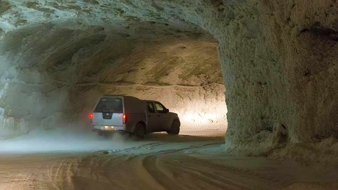 Vehicle driving through Slanic Salt Mine tunnel near Bucharest.