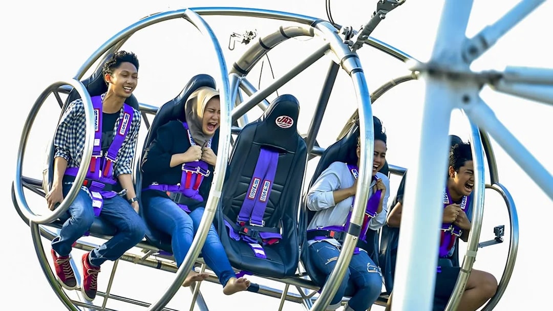 People enjoying the Slingshot ride in Singapore, experiencing thrill and excitement.