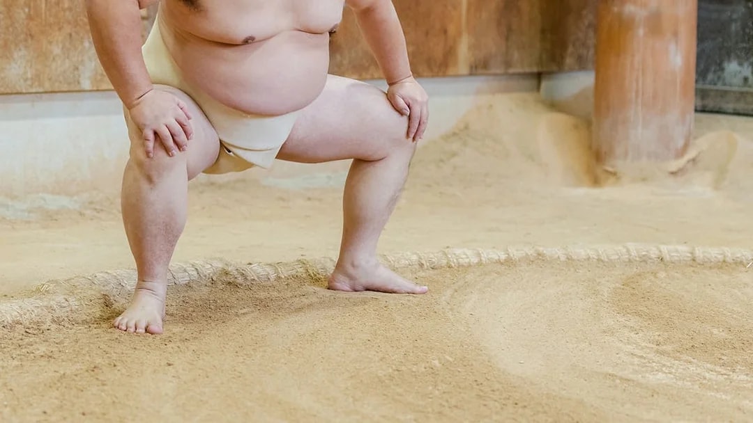 Sumo wrestler practicing in a Tokyo training ring.