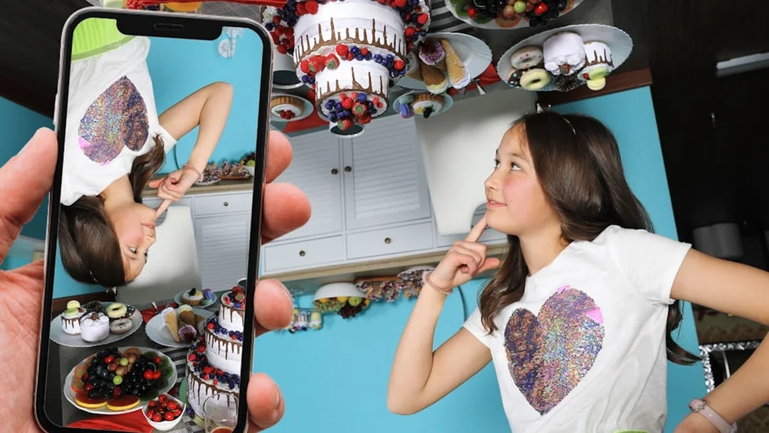 Girl in a room with upside-down desserts at the Big Fun Museum.