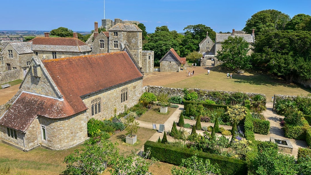Carisbrooke Castle gardens and historic buildings on a sunny day, Isle of Wight.