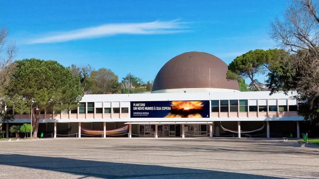 Navy Planetarium building with a large dome and surrounding trees.