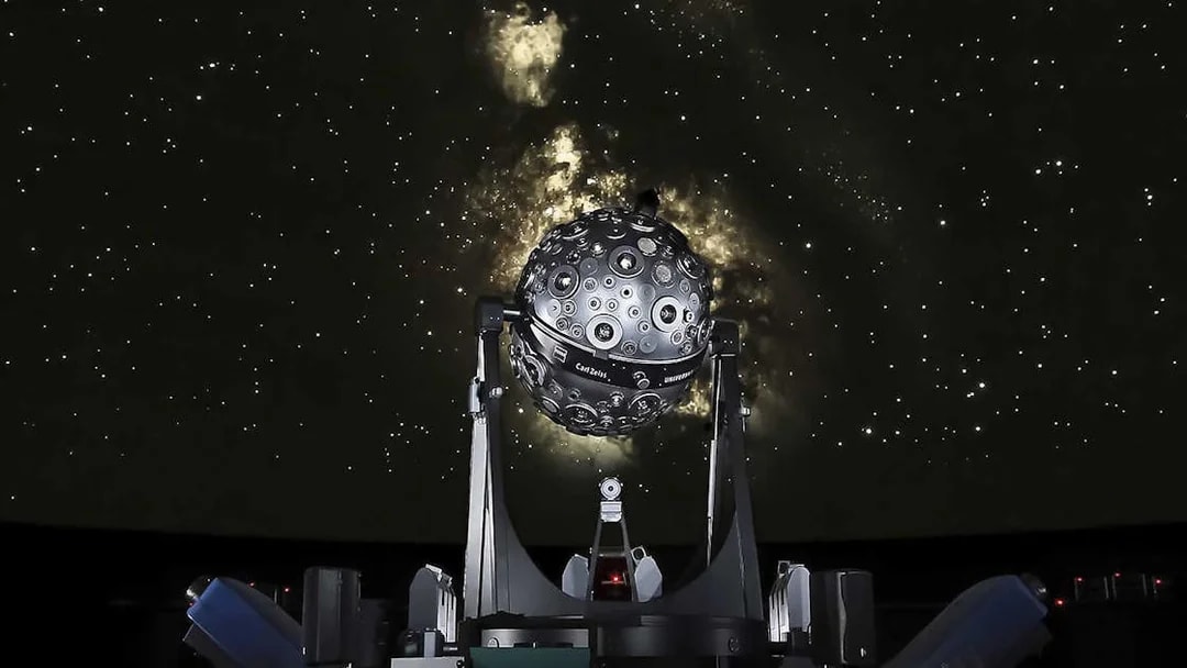 Planetarium projector under a starry sky at the Navy Planetarium.