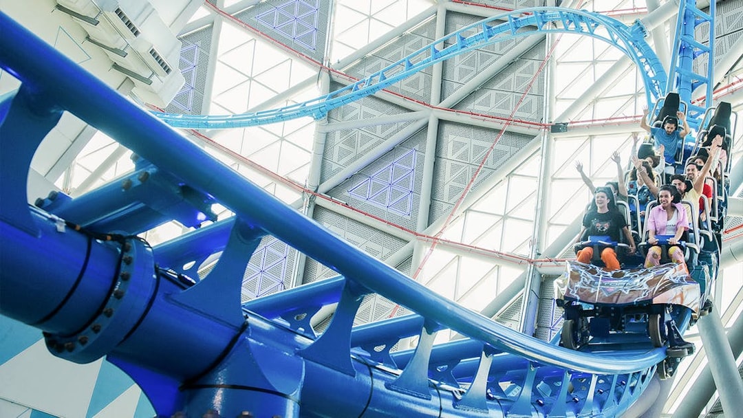 Riders on The Storm Coaster in Dubai, experiencing a thrilling indoor roller coaster.
