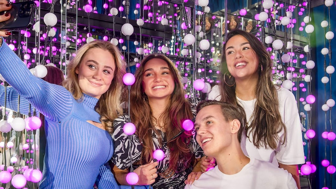 Group enjoying interactive light display at The TUBE exhibit.