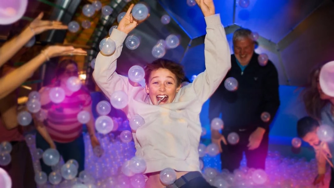 Person enjoying bubble room experience at The TUBE in Copenhagen.
