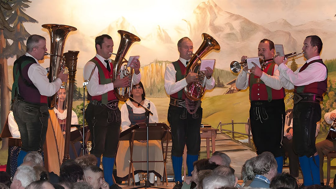 Musicians in traditional attire perform at Tyrolean Evening Folk Show with the Gundolf Family.